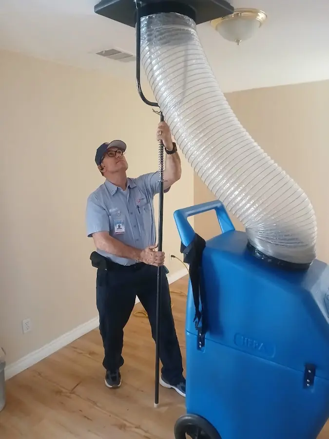 Furnace Tune-Up technician using HEPA equipment in Hutchinson